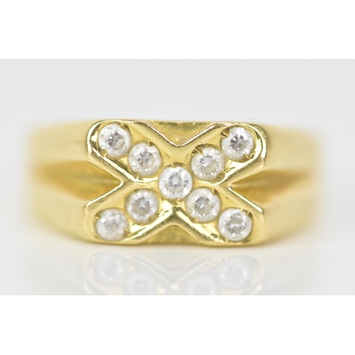 143 - A yellow gold ring, inset with nine paste stones in a cross configuration, ring size T, testing as 1... 