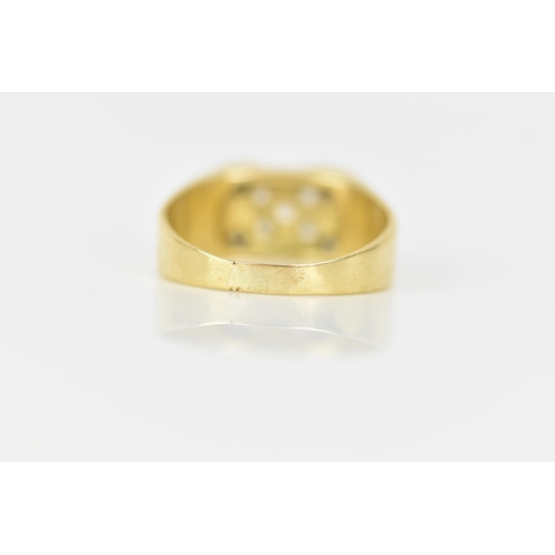 143 - A yellow gold ring, inset with nine paste stones in a cross configuration, ring size T, testing as 1... 