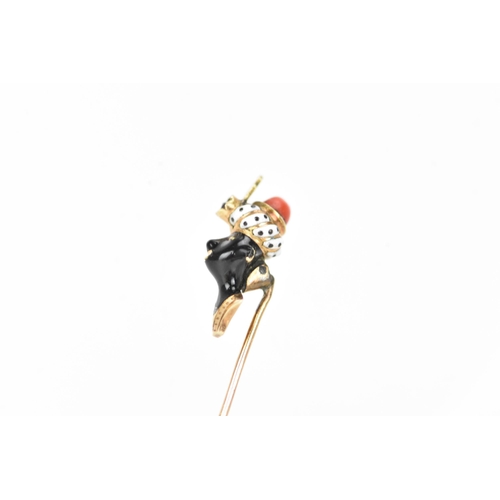 147 - A 19th century blackamoor yellow gold stick pin modelled as a bust wearing a turban, coral, garnet a... 