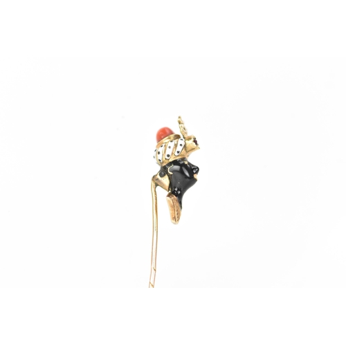 147 - A 19th century blackamoor yellow gold stick pin modelled as a bust wearing a turban, coral, garnet a... 