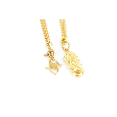 162 - An 18ct yellow gold necklace with two 22ct gold pendants, the curb chain link necklace having a bolt... 