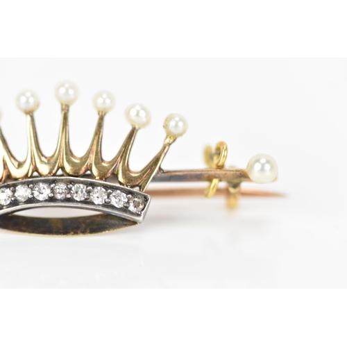 165 - A Victorian yellow metal pearl and diamond coronet/crown brooch, the crown inset with a band of nine... 