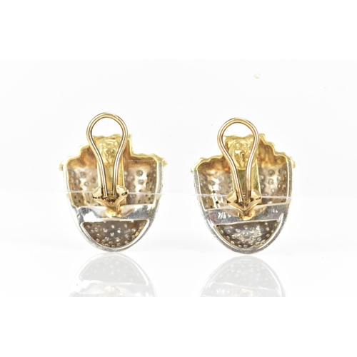 173 - A pair of 18ct yellow and white gold diamond pave set earrings, each fashioned as acorns with drop d... 