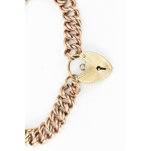 174 - A 9ct rose gold double curb link bracelet, with a yellow gold heart shaped padlock clasp, 16.5cm, 9.... 