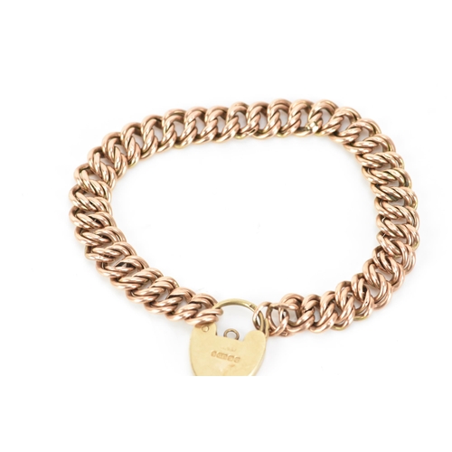 174 - A 9ct rose gold double curb link bracelet, with a yellow gold heart shaped padlock clasp, 16.5cm, 9.... 