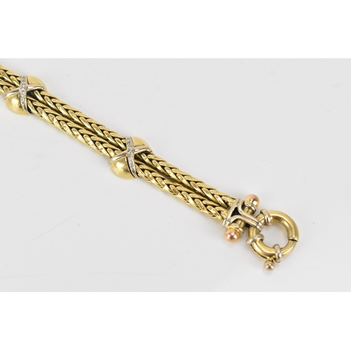 177 - An 18ct gold double spegia bracelet, with three cross and domed sections, each set with fifteen roun... 