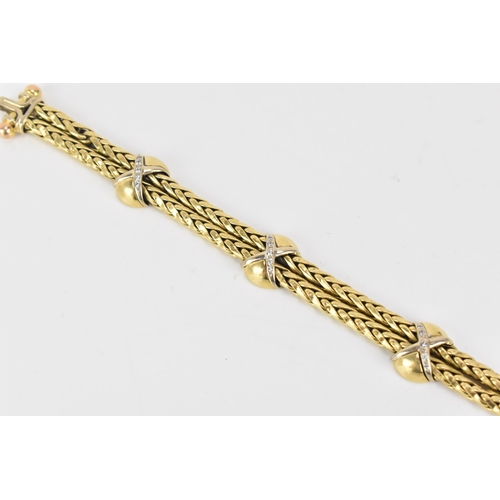 177 - An 18ct gold double spegia bracelet, with three cross and domed sections, each set with fifteen roun... 