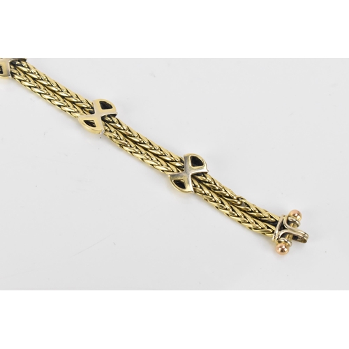 177 - An 18ct gold double spegia bracelet, with three cross and domed sections, each set with fifteen roun... 