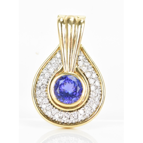 180 - An 18ct gold tanzanite and diamond pendant, the tanzanite stone set in a rub over setting, 8.5mm, su... 