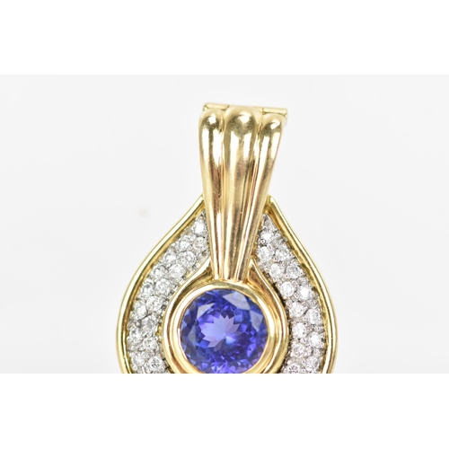 180 - An 18ct gold tanzanite and diamond pendant, the tanzanite stone set in a rub over setting, 8.5mm, su... 