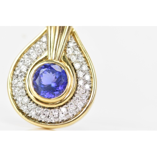 180 - An 18ct gold tanzanite and diamond pendant, the tanzanite stone set in a rub over setting, 8.5mm, su... 