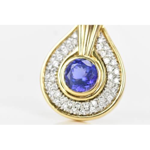 180 - An 18ct gold tanzanite and diamond pendant, the tanzanite stone set in a rub over setting, 8.5mm, su... 