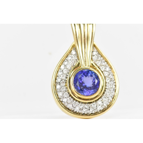 180 - An 18ct gold tanzanite and diamond pendant, the tanzanite stone set in a rub over setting, 8.5mm, su... 