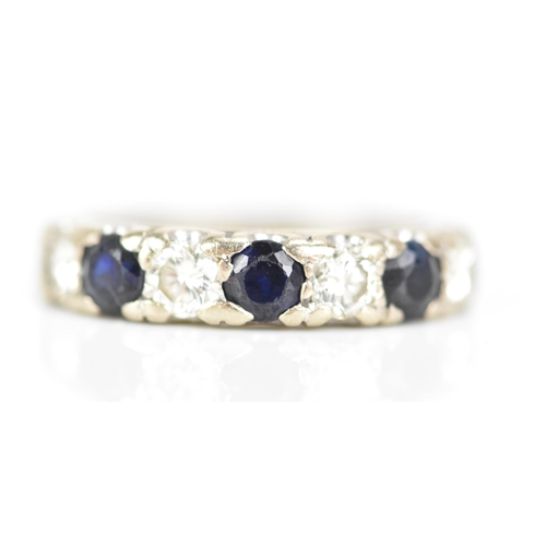 181 - An 18ct white gold half eternity ring, set with three sapphires, each approx 3.3mm x 3mm and four ro... 