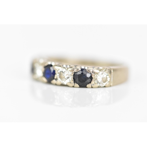 181 - An 18ct white gold half eternity ring, set with three sapphires, each approx 3.3mm x 3mm and four ro... 