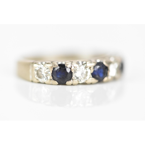 181 - An 18ct white gold half eternity ring, set with three sapphires, each approx 3.3mm x 3mm and four ro... 