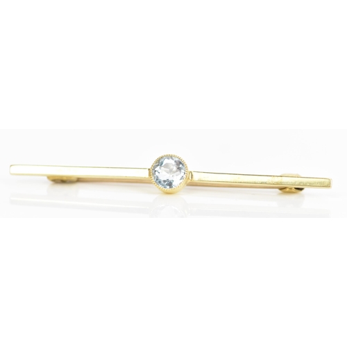 183 - An Edwardian yellow metal bar brooch, inset with a central brilliant cut aquamarine, 5mm, unmarked, ... 