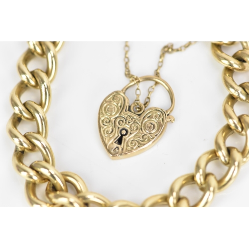 185 - A 9ct rose gold curb link chain bracelet, having a scroll engraved heart shaped padlock clasp and sa... 