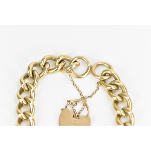 185 - A 9ct rose gold curb link chain bracelet, having a scroll engraved heart shaped padlock clasp and sa... 