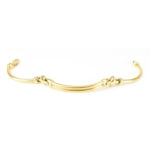 203 - An 18ct yellow gold bracelet, formed as three hoop connected bars, with a lobster clasp, stamped 750... 