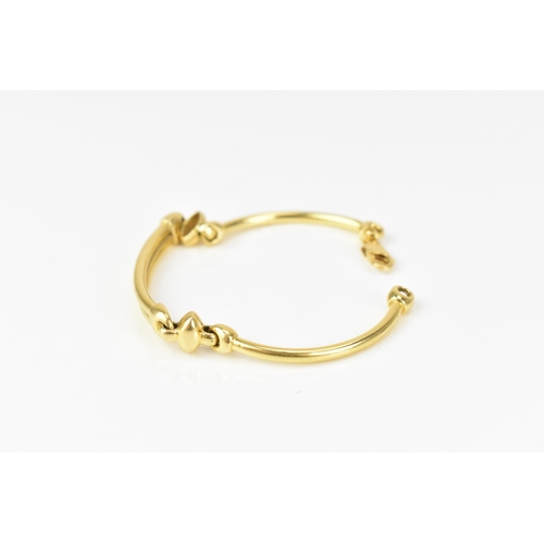 203 - An 18ct yellow gold bracelet, formed as three hoop connected bars, with a lobster clasp, stamped 750... 