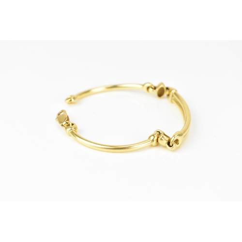 203 - An 18ct yellow gold bracelet, formed as three hoop connected bars, with a lobster clasp, stamped 750... 