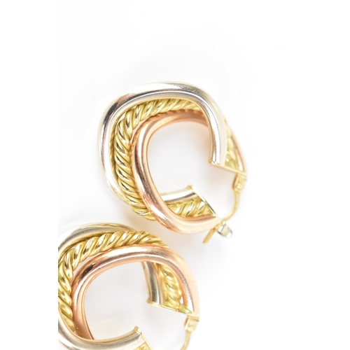 207 - A pair of 18ct tri-coloured gold hoop earrings, each having a central yellow gold rope twist entwine... 