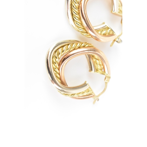 207 - A pair of 18ct tri-coloured gold hoop earrings, each having a central yellow gold rope twist entwine... 