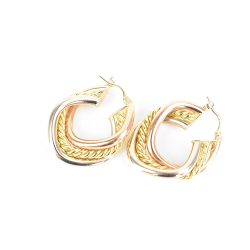 207 - A pair of 18ct tri-coloured gold hoop earrings, each having a central yellow gold rope twist entwine... 