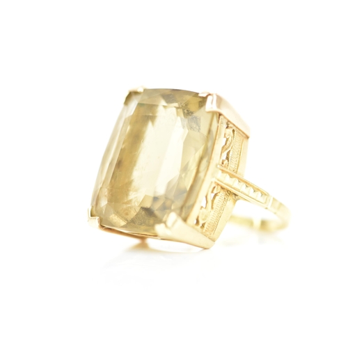 210 - An 18ct yellow gold dress ring, inset with a large faceted cut citrine, 21.1mm x 17.8mm, with a pier... 