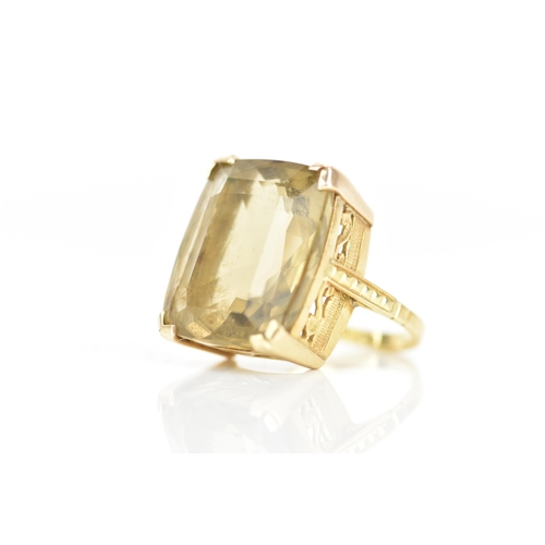 210 - An 18ct yellow gold dress ring, inset with a large faceted cut citrine, 21.1mm x 17.8mm, with a pier... 