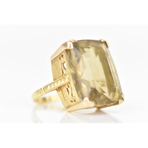 210 - An 18ct yellow gold dress ring, inset with a large faceted cut citrine, 21.1mm x 17.8mm, with a pier... 