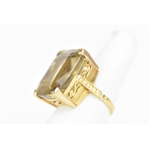 210 - An 18ct yellow gold dress ring, inset with a large faceted cut citrine, 21.1mm x 17.8mm, with a pier... 