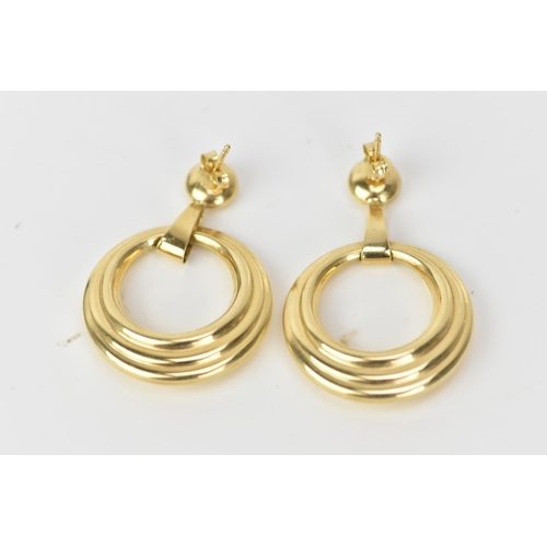 212 - A pair of 14ct yellow gold hoop earrings, each having suspension rings and butterfly backs, stamped ... 