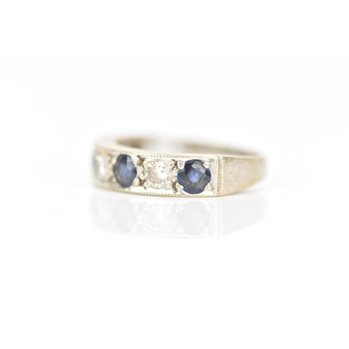 216 - An 18ct white gold diamond and sapphire half eternity ring, inset with four sapphires, each approx 3... 