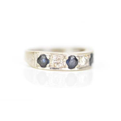 216 - An 18ct white gold diamond and sapphire half eternity ring, inset with four sapphires, each approx 3... 