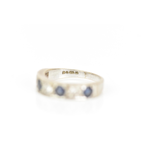 216 - An 18ct white gold diamond and sapphire half eternity ring, inset with four sapphires, each approx 3... 