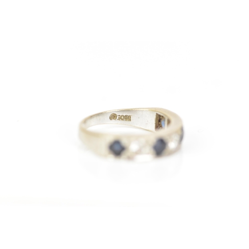 216 - An 18ct white gold diamond and sapphire half eternity ring, inset with four sapphires, each approx 3... 