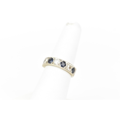 216 - An 18ct white gold diamond and sapphire half eternity ring, inset with four sapphires, each approx 3... 