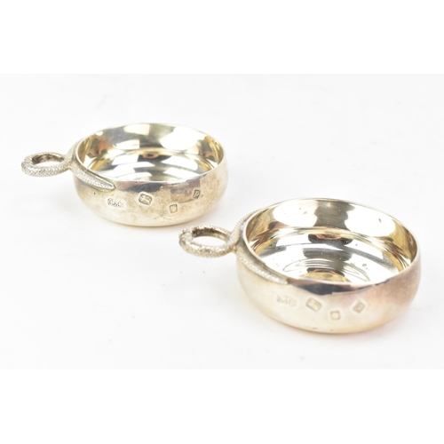 220 - A pair of Elizabeth II silver tastevins, by Carrington & Co, hallmarked London 1970, each having two... 