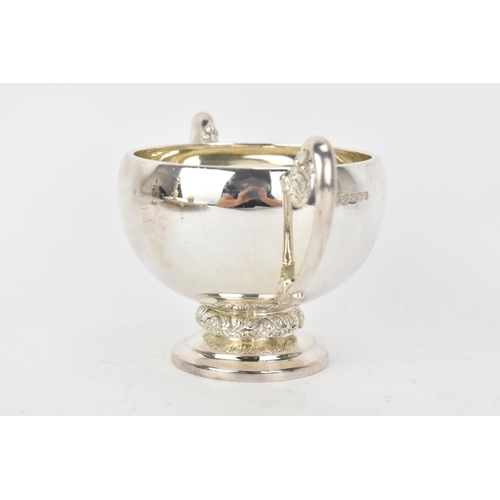 221 - An Elizabeth II silver twin handled sugar bowl, by Harrods Ltd, hallmarked Sheffield 1962, cast with... 