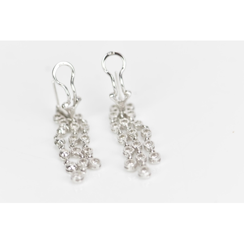 229 - A pair of 18ct white gold and diamond earrings, each composed of three articulated tassel drops and ... 