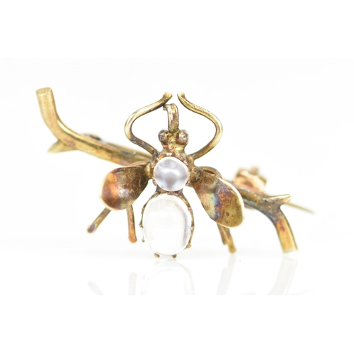 232 - A late Victorian yellow metal insect brooch, fashioned as a winged insect perched on a branch and in... 