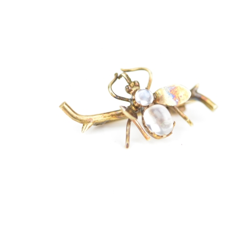 232 - A late Victorian yellow metal insect brooch, fashioned as a winged insect perched on a branch and in... 