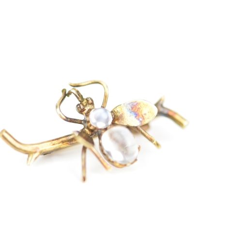 232 - A late Victorian yellow metal insect brooch, fashioned as a winged insect perched on a branch and in... 