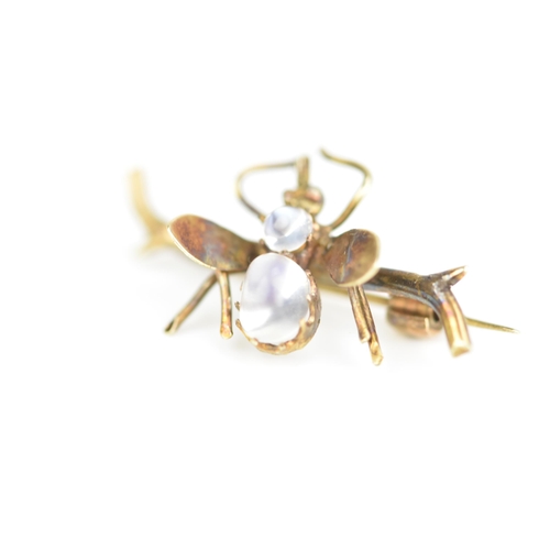 232 - A late Victorian yellow metal insect brooch, fashioned as a winged insect perched on a branch and in... 