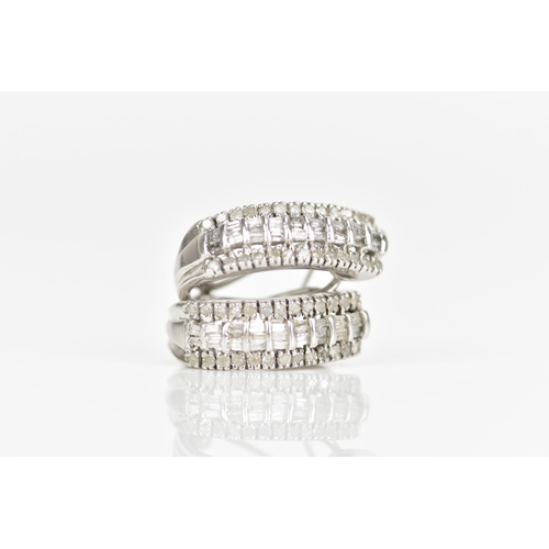 235 - A pair of 10ct white gold diamond earrings, each inset with a row of baguette cut diamonds surrounde... 