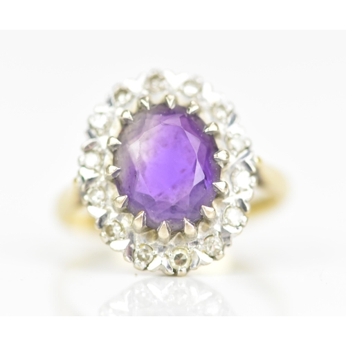 239 - An 18ct yellow gold amethyst and diamond cluster ring, the oval faceted cut amethyst in a caw settin... 