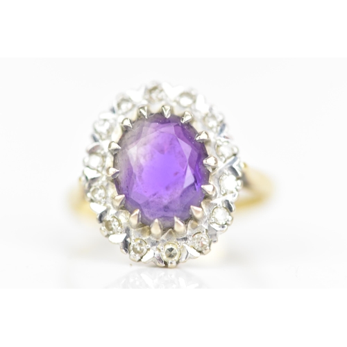 239 - An 18ct yellow gold amethyst and diamond cluster ring, the oval faceted cut amethyst in a caw settin... 