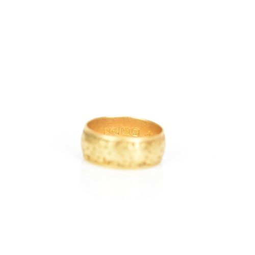 240 - An 18ct yellow gold wedding band, engraved with a floral design, ring size P 1/2, 7.4 grams
If there... 